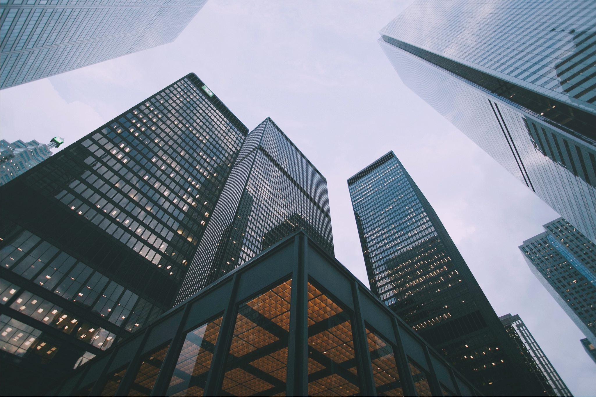 Low-angle view of massive corporate skyscrapers, symbolizing ZeroTier's capability for large-scale enterprise and hybrid cloud deployment.